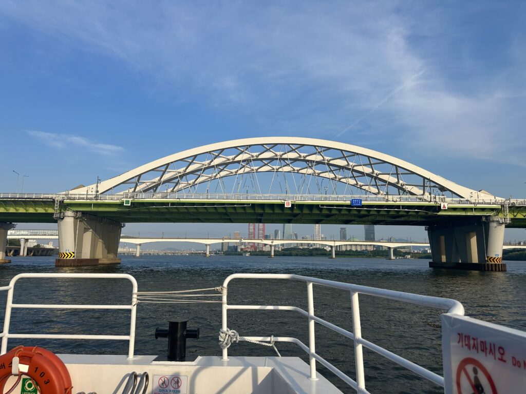 View of a bridge over the Han River from the outer deck of the Hangang Bus in Seoul.